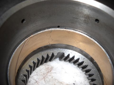 1993 Ford C-150 (Centurion Conversions) - This image shows a worn transmission component, likely from an E4OD rebuild, exhibiting significant scoring and damage to the gear teeth.