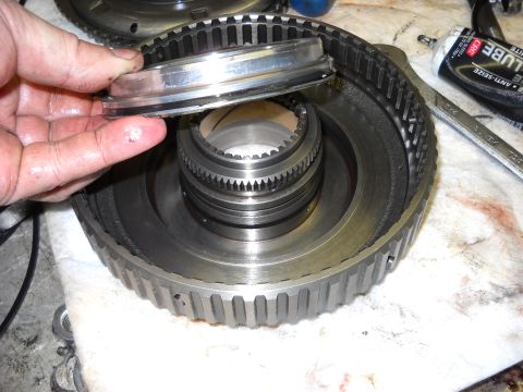 1993 Ford C-150 (Centurion Conversions) - Close-up of a transmission part being disassembled.