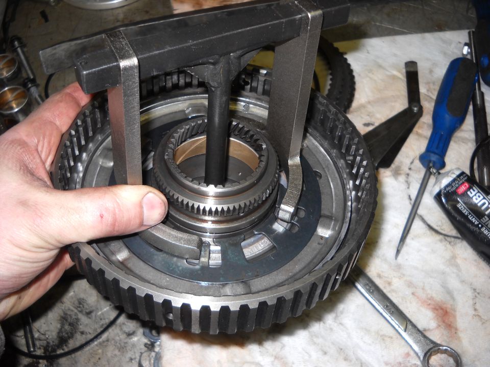 Transmission planetary gear set being worked on with a puller tool