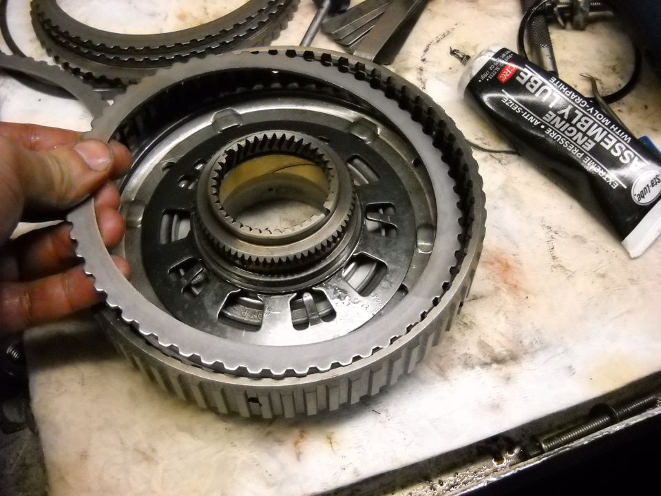 Close-up of transmission clutch pack and input shaft with assembly lube tube nearby