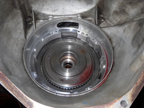 1993 Ford C-150 (Centurion Conversions) - Close-up view of a transmission's torque converter housing, revealing internal mechanical parts.