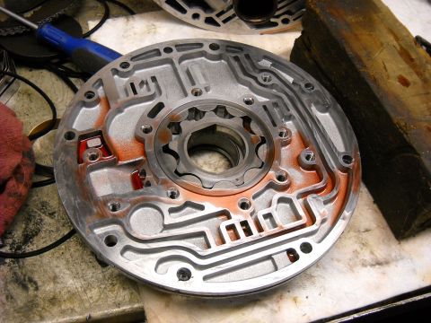 1993 Ford C-150 (Centurion Conversions) - Close-up of a disassembled automatic transmission valve body, showing internal channels and a splined shaft.