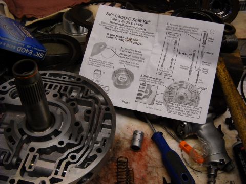 1993 Ford C-150 (Centurion Conversions) - Close-up of a transmission valve body and installation instructions for an E4OD-C Shift Kit.