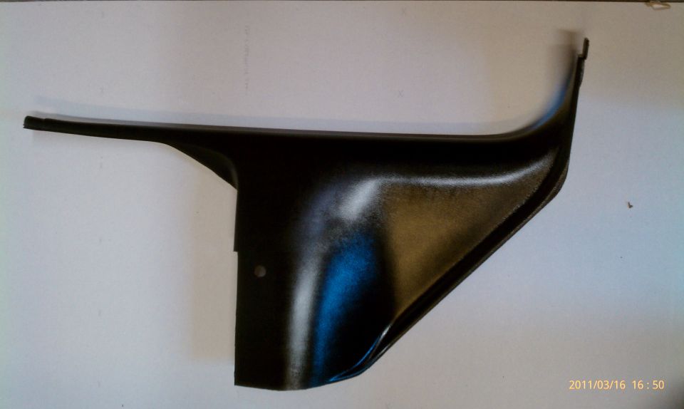 Black plastic interior trim piece with a curved edge and a flat extension