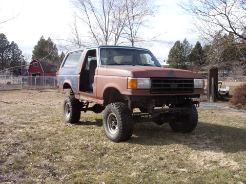 1988 Ford Bronco - This lifted Ford Bronco is missing its doors and appears to be in primer.
