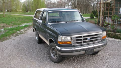 1992 Ford Bronco - This 1992 Ford Bronco is seen from a 3q-front angle, its dark green paint and white removable top.