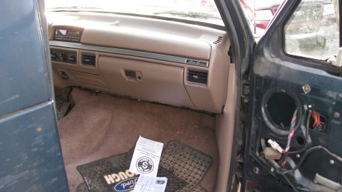 1992 Ford Bronco - Interior view of a 1992 Ford Bronco, dashboard and removed door panel visible.