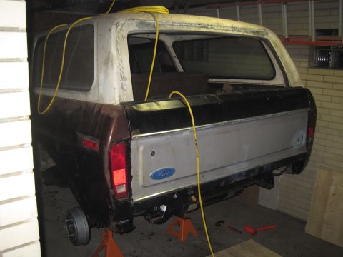 1979 Ford Bronco - This 1979 Ford Bronco is shown from the rear while being worked on, supported by jack stands.