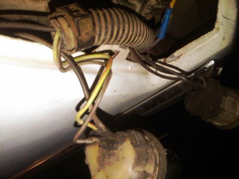 1982 Ford Bronco - This image shows a damaged wiring harness with exposed wires and connectors, likely requiring repair.