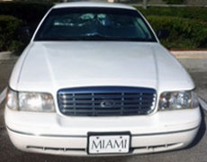 1999 Mercury Grand Marquis - A white sedan is parked outdoors, showing its front grille and headlights.