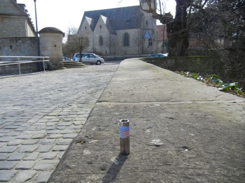 1999 Lincoln Town Car - A silver minivan is parked on a cobblestone street in front of a church.