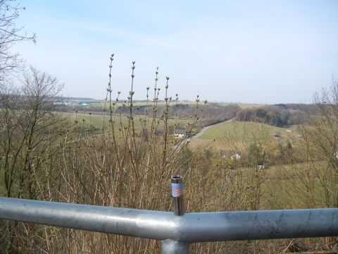 1999 Lincoln Town Car - A scenic view of rolling hills and fields, with a lighter resting on a metal railing in the foreground.