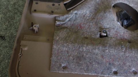1994 Ford Bronco - This is a close-up view of a car's interior door panel, showing the insulation and mounting points.