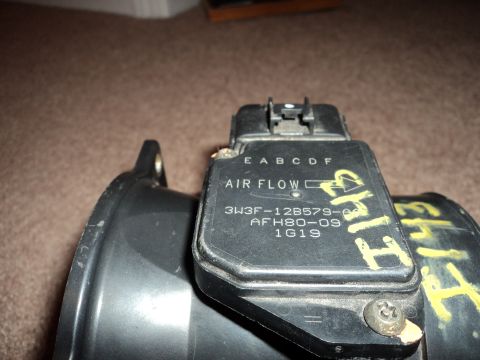 2004 Mercury Grand Marquis - Close-up of an air flow sensor with visible part numbers and markings.