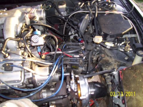 1995 Ford Probe - Custom engine bay modifications are visible, including a turbocharger and aftermarket fuel lines.