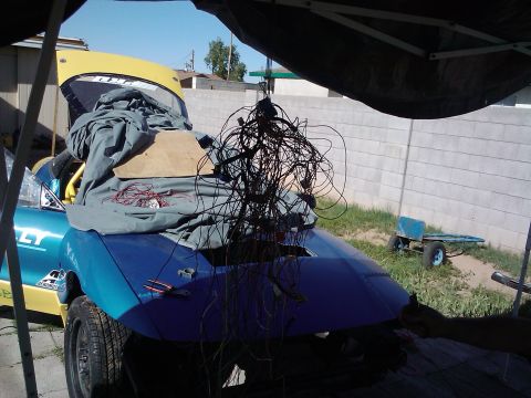1995 Ford Probe - Car undergoing repairs with a large bundle of wires obscuring the view.