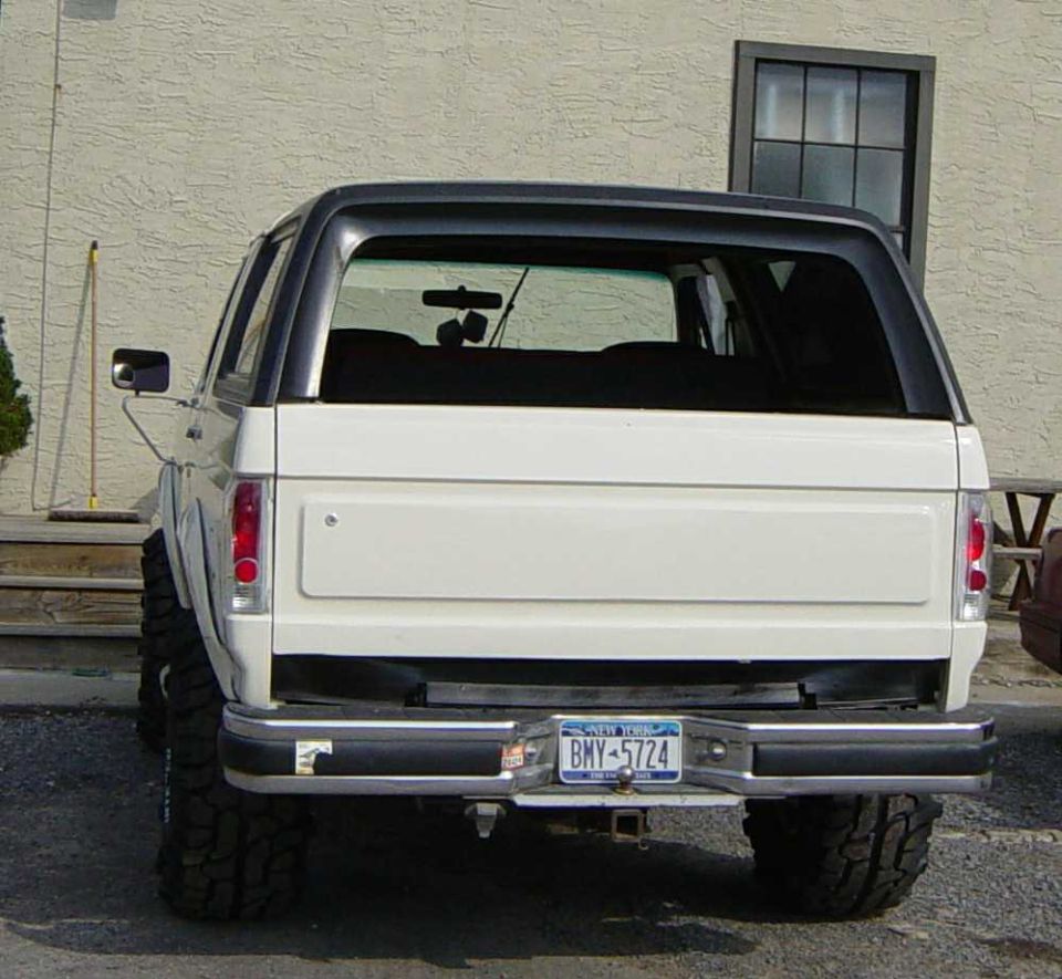 1990 Ford Bronco rear view, white with black top, New York license plate BMY-5724