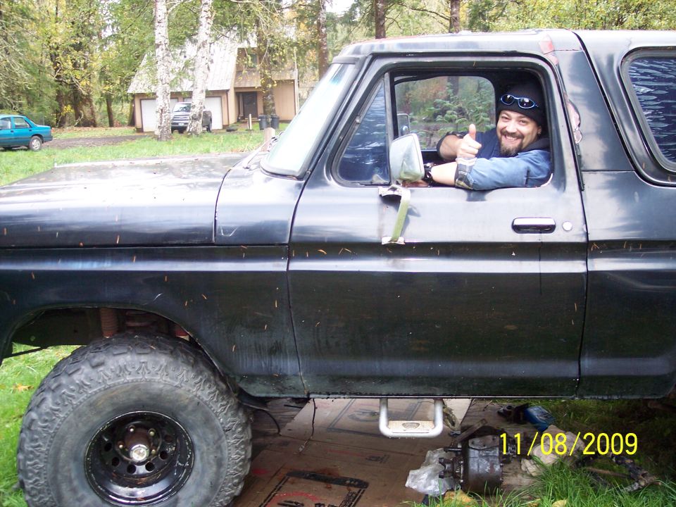 Man in black 1978 Ford Bronco gives thumbs up from driver's seat