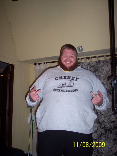 1978 Ford Bronco - A man in a sweatshirt with 'Cheney Cheerleading' printed on it is shown giving the middle finger.
