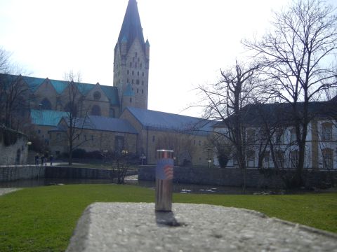 1999 Lincoln Town Car - A lighter sits on a stone ledge in front of a large cathedral and surrounding buildings.