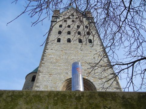 1999 Lincoln Town Car - A can of spray paint is positioned in front of a large stone tower under a clear blue sky.
