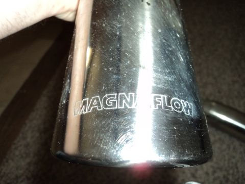 2004 Mercury Grand Marquis - Close-up of a MagnaFlow exhaust tip, showing the brand name etched on the surface.