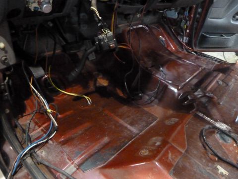 1993 Ford C-150 (Centurion Conversions) - The interior of a vehicle shows exposed wiring and bare floor, suggesting ongoing work or a stripped-down state.