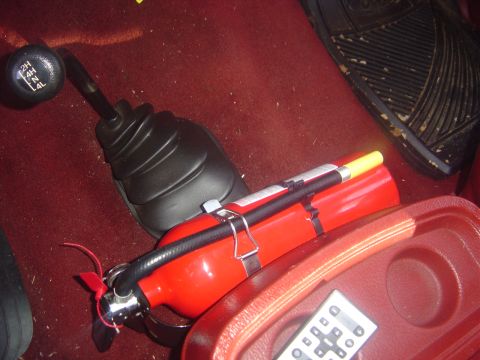 1986 Ford Bronco - Interior view of a fire extinguisher and a 4x4 shifter with gear selection markings.