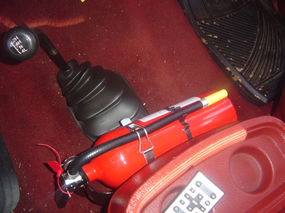 Red fire extinguisher and 4x4 shifter with 2H, 4H, 2L, 4L markings