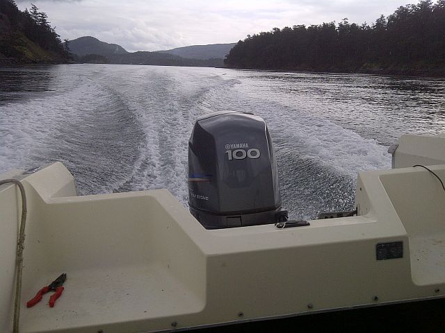 Boat moving through water, showing Yamaha 100 outboard motor and wake