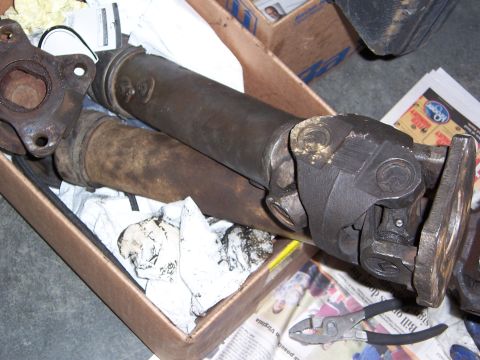 1992 Ford Bronco - Driveshaft components are shown in a cardboard box, resting on newspaper.