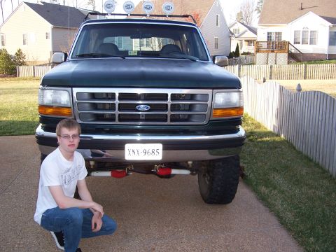 1992 Ford Bronco - A person poses in front of a Ford Bronco, which appears to be from the early to mid-1990s.