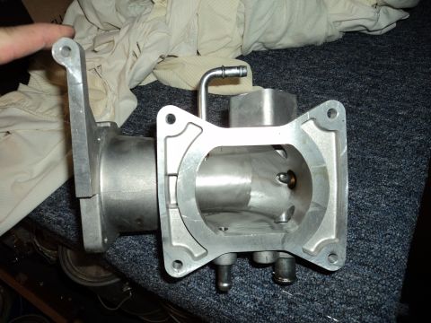2004 Mercury Grand Marquis - Aluminum throttle body with intake manifold flange and vacuum nipple visible.