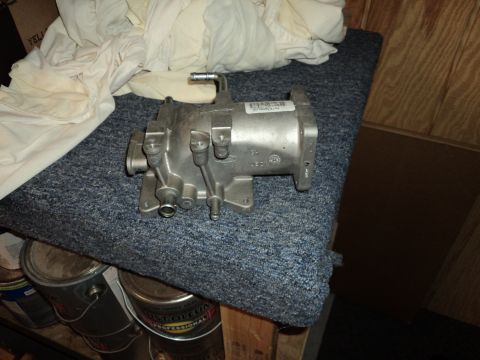 2004 Mercury Grand Marquis - A Ford throttle body part is shown resting on a textured surface, with paint cans visible underneath.