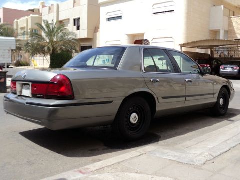 2001 Mercury Grand Marquis - A gray 2001 Mercury Grand Marquis is seen from a rear three-quarter angle on a sunny day.
