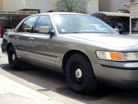2001 Mercury Grand Marquis - This 2001 Mercury Grand Marquis is shown from the front three-quarter view, its steel wheels.