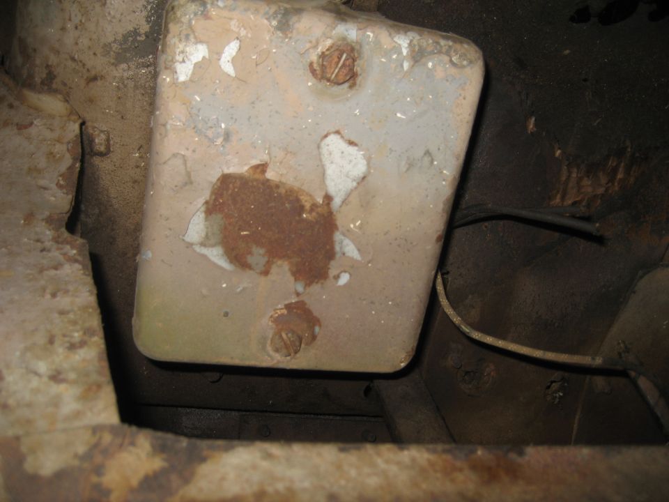Underbody part with rust and peeling paint