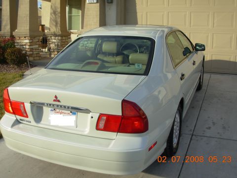 1999 Mitsubishi Diamante - Rear view of a 1999 Mitsubishi Diamante sedan parked in front of a garage and house.
