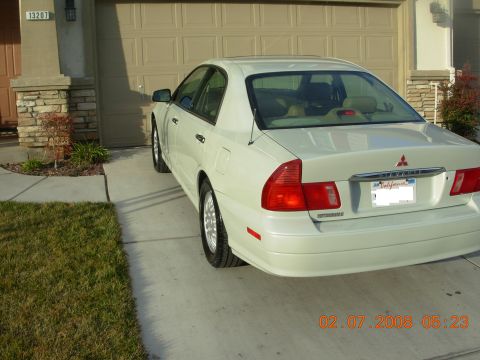 1999 Mitsubishi Diamante - Rear view of a white sedan with a visible Mitsubishi badge on the trunk.