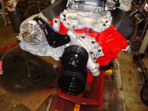1989 Ford Bronco - Close-up view of a partially assembled engine, showing the alternator and pulley system.