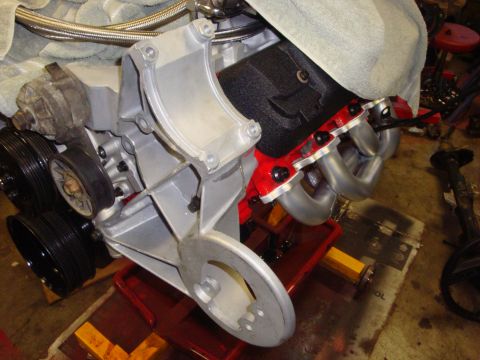 1989 Ford Bronco - Close-up view of an engine block assembly, exhaust headers and pulleys.