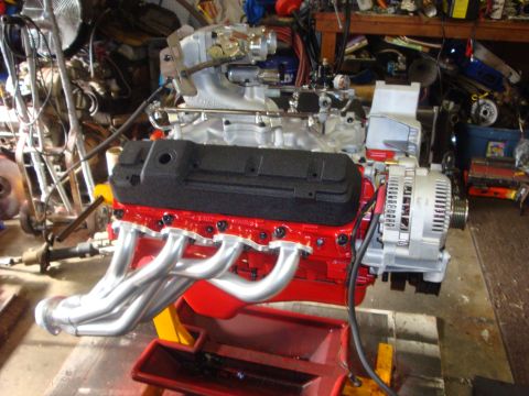 1989 Ford Bronco - A rebuilt engine sits on a stand, ready for installation.