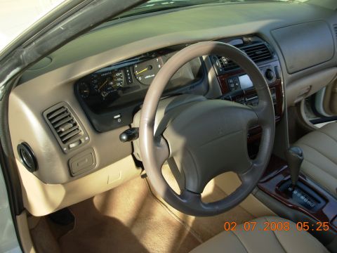 1999 Mitsubishi Diamante - Interior view of a car's dashboard and steering wheel, showing the driver's side controls.