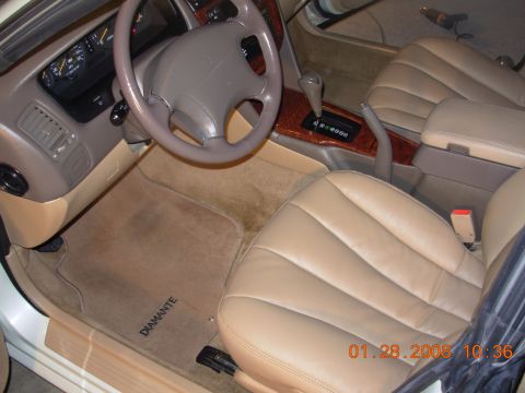 1999 Mitsubishi Diamante - A close-up view of a car's interior, showing the steering wheel and dashboard area.