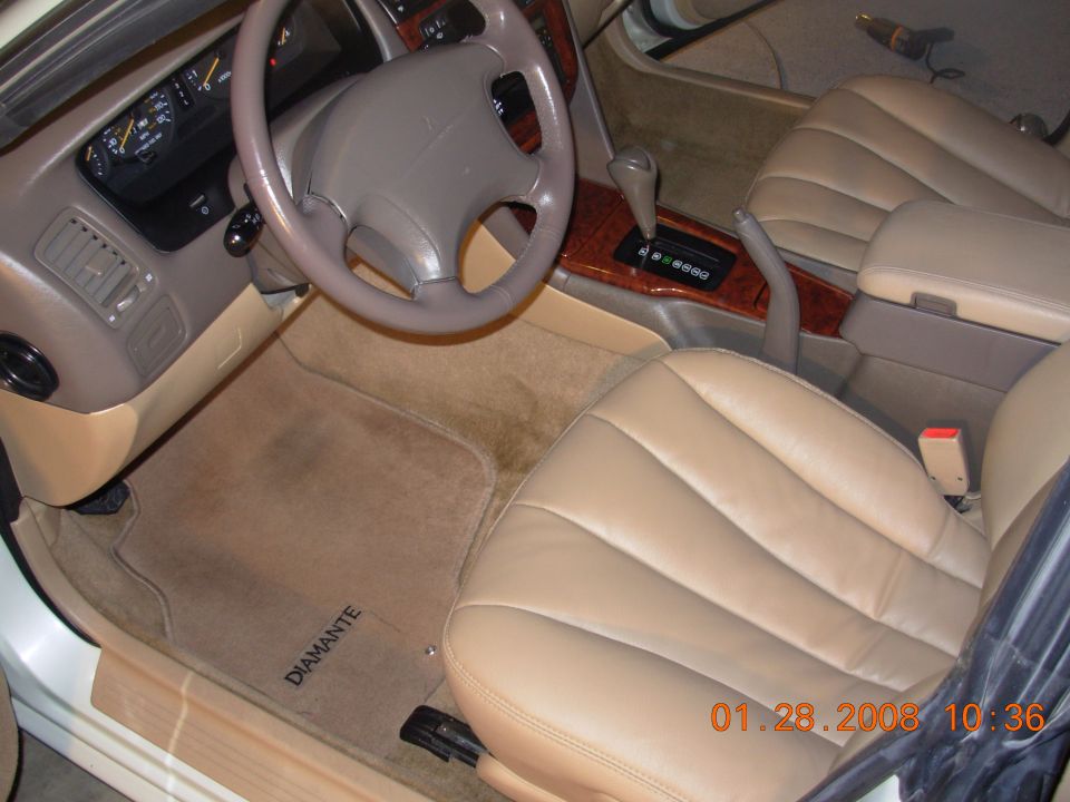 Car interior with steering wheel and dashboard visible