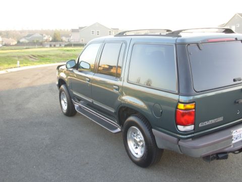1997 Ford Explorer - A dark green Ford Explorer is shown from the rear quarter angle on a paved surface.