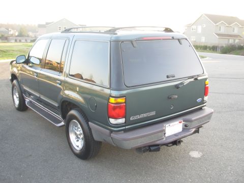 1997 Ford Explorer - This 1997 Ford Explorer is seen from the rear, tinted windows and a trailer hitch.