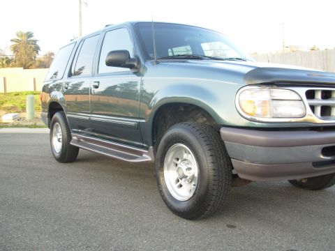 1997 Ford Explorer - Side view of a 1997 Ford Explorer SUV parked outdoors.