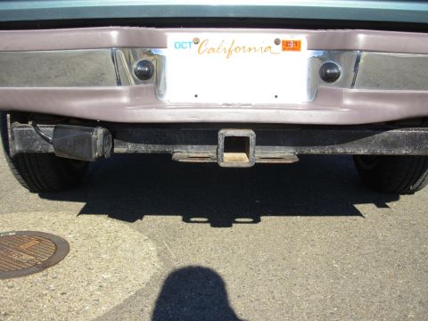 1997 Ford Explorer - The rear of a vehicle shows a trailer hitch and a California license plate with an expiration sticker for 2011.
