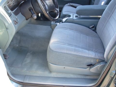 1997 Ford Explorer - The interior of a 1997 Ford Explorer is shown, the driver's seat and dashboard area.